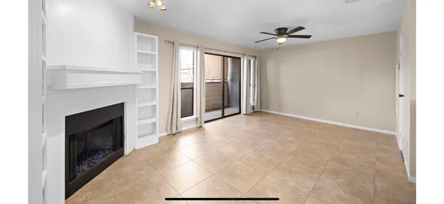 a view of an empty room with a fireplace