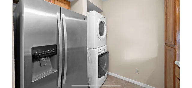 a kitchen with stainless steel appliances granite countertop a refrigerator and a stove