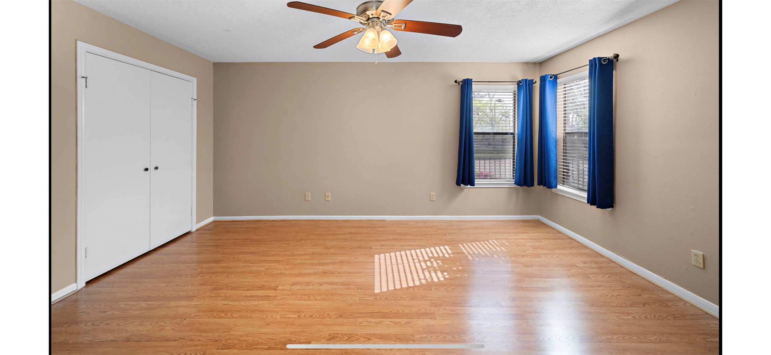 12755 Mill Ridge Drive, Unit 202 Cypress, TX 77429 - Photo 8 of 17 a view of an empty room with window and wooden floor