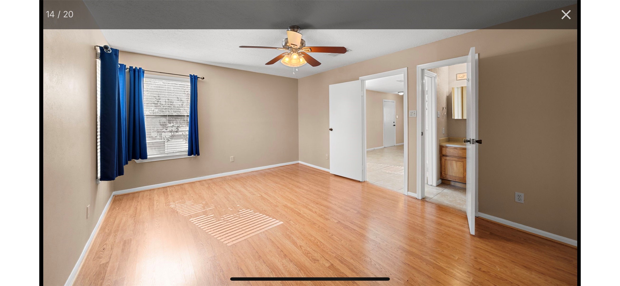 12755 Mill Ridge Drive, Unit 202 Cypress, TX 77429 - Photo 9 of 17 a view of empty room with wooden floor and fan