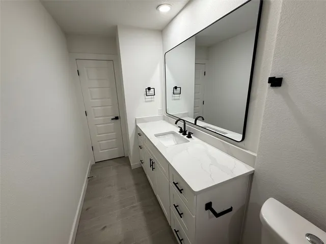 a bathroom with a sink mirror toilet and bathtub