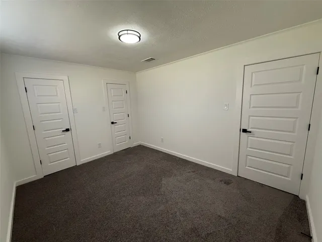 an empty room with window and pillar in it