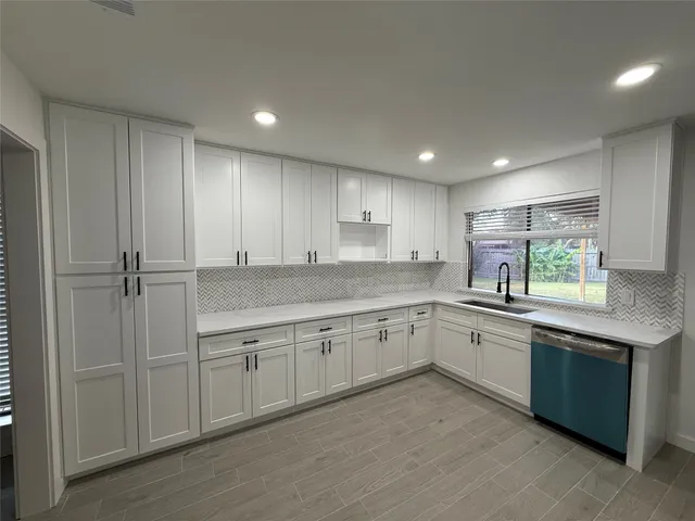 a kitchen with sink cabinets and window