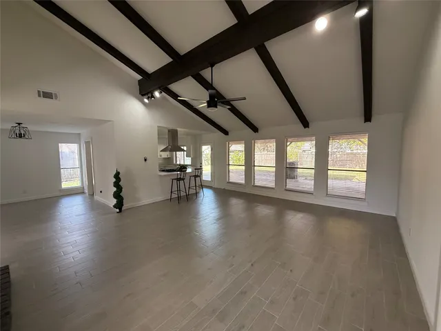a view of a hall with wooden floor