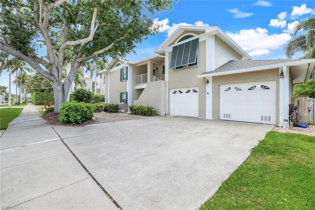 a view of a white house with a yard and plants