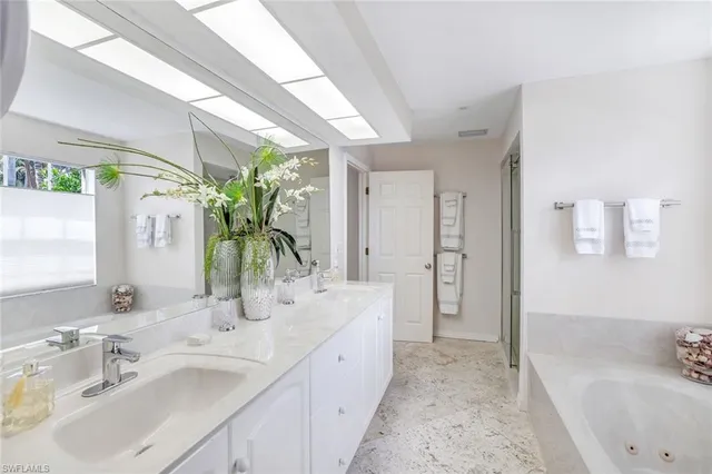 a spacious bathroom with a double vanity sink and a mirror