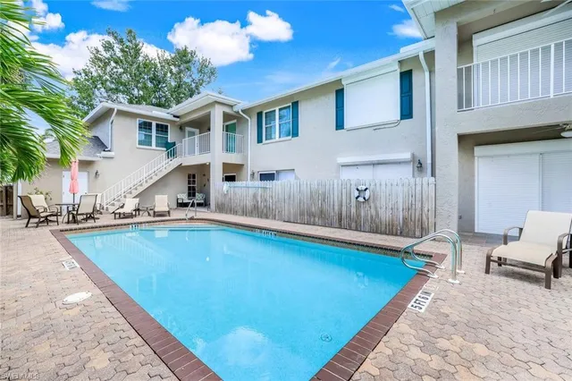 a swimming pool with outdoor seating