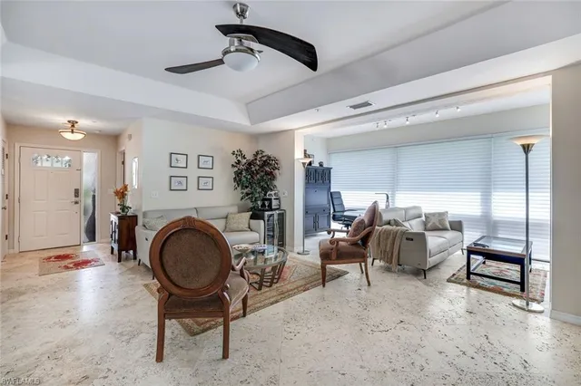 a living room with furniture a wooden floor and a chandelier