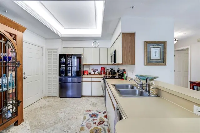 a large kitchen with a lot of cabinets and stainless steel appliances