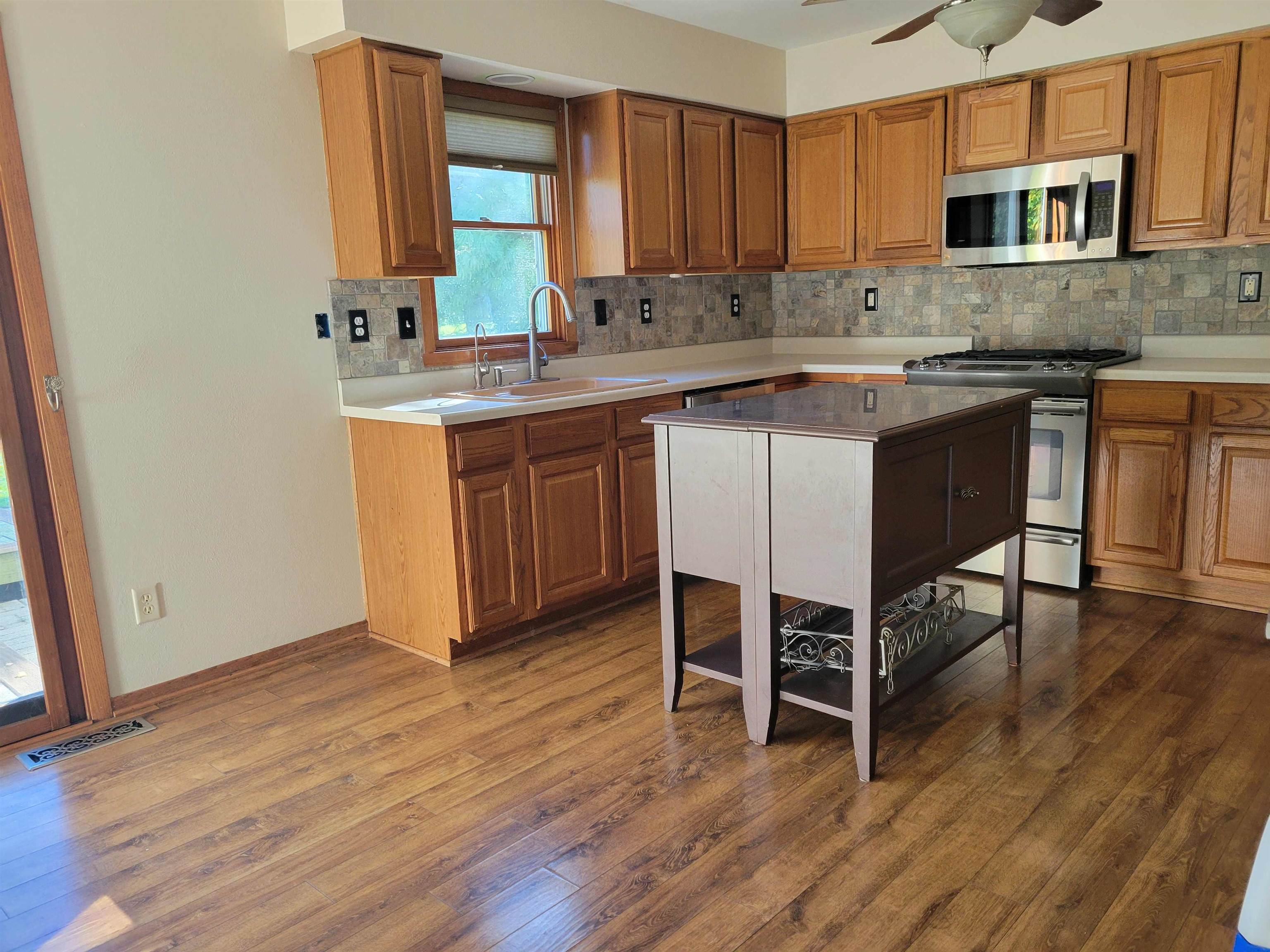 1126 Old Hunter Run Byron, IL 61010 - Photo 12 of 24 a kitchen with a sink cabinets and wooden floor