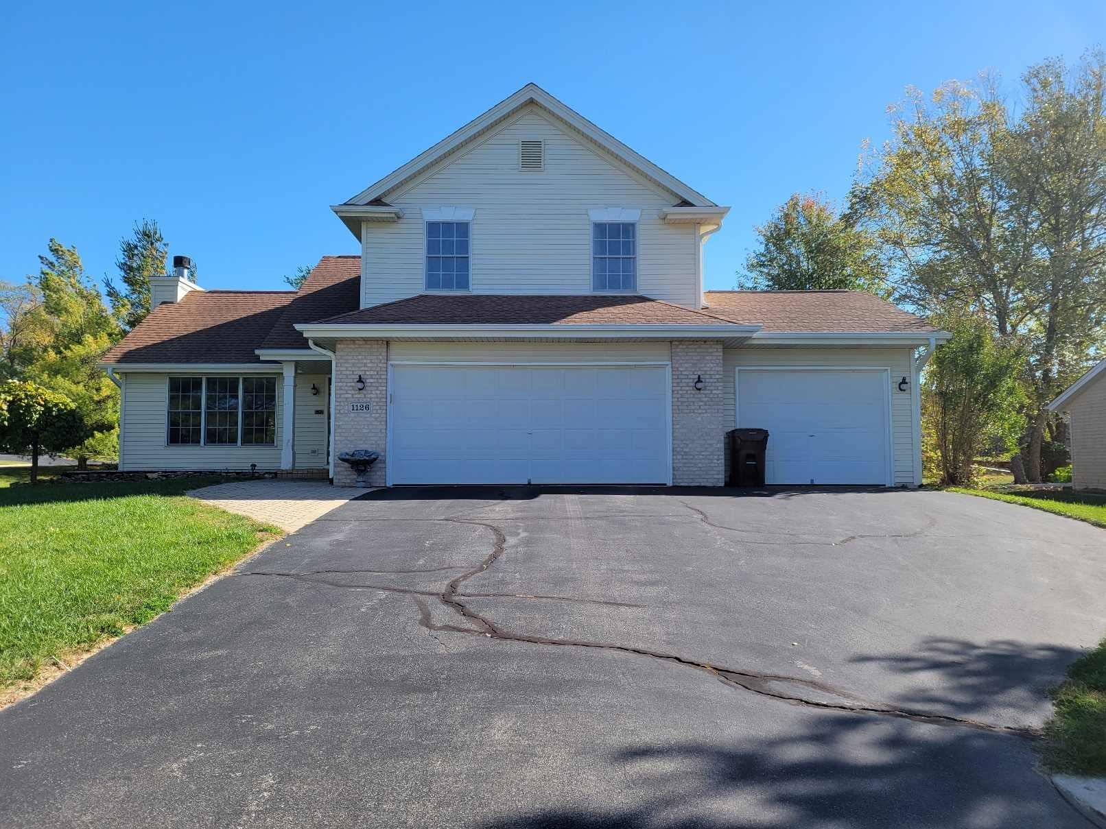 1126 Old Hunter Run Byron, IL 61010 - Photo 2 of 24 a front view of a house with a yard and garage
