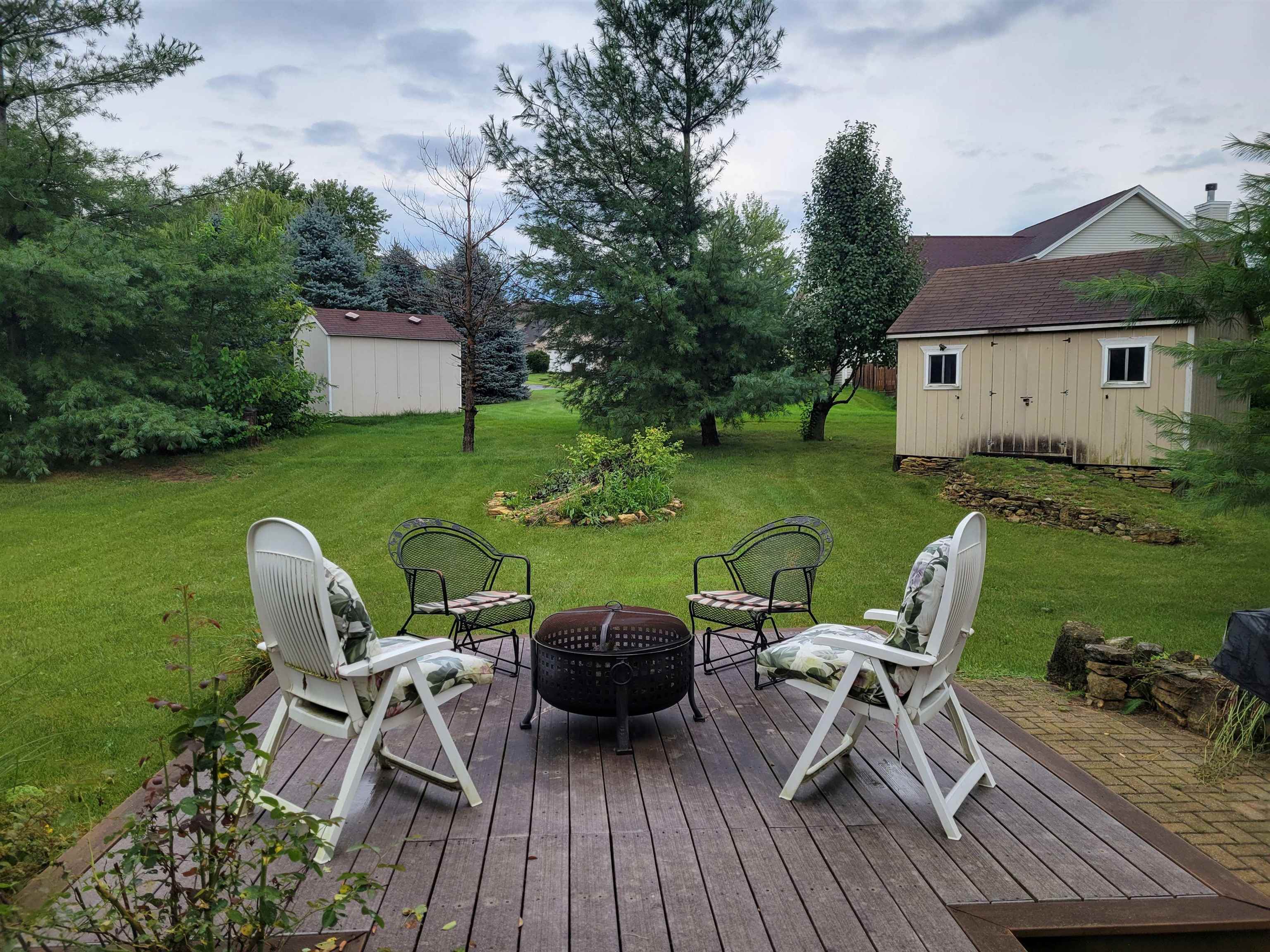 1126 Old Hunter Run Byron, IL 61010 - Photo 22 of 24 a view of a patio with table and chairs with wooden floor and fence