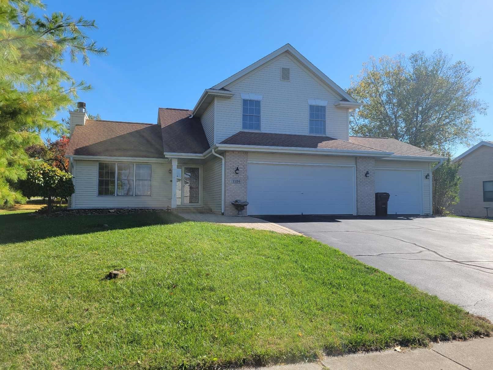 1126 Old Hunter Run Byron, IL 61010 - Photo 3 of 24 a front view of a house with a garden