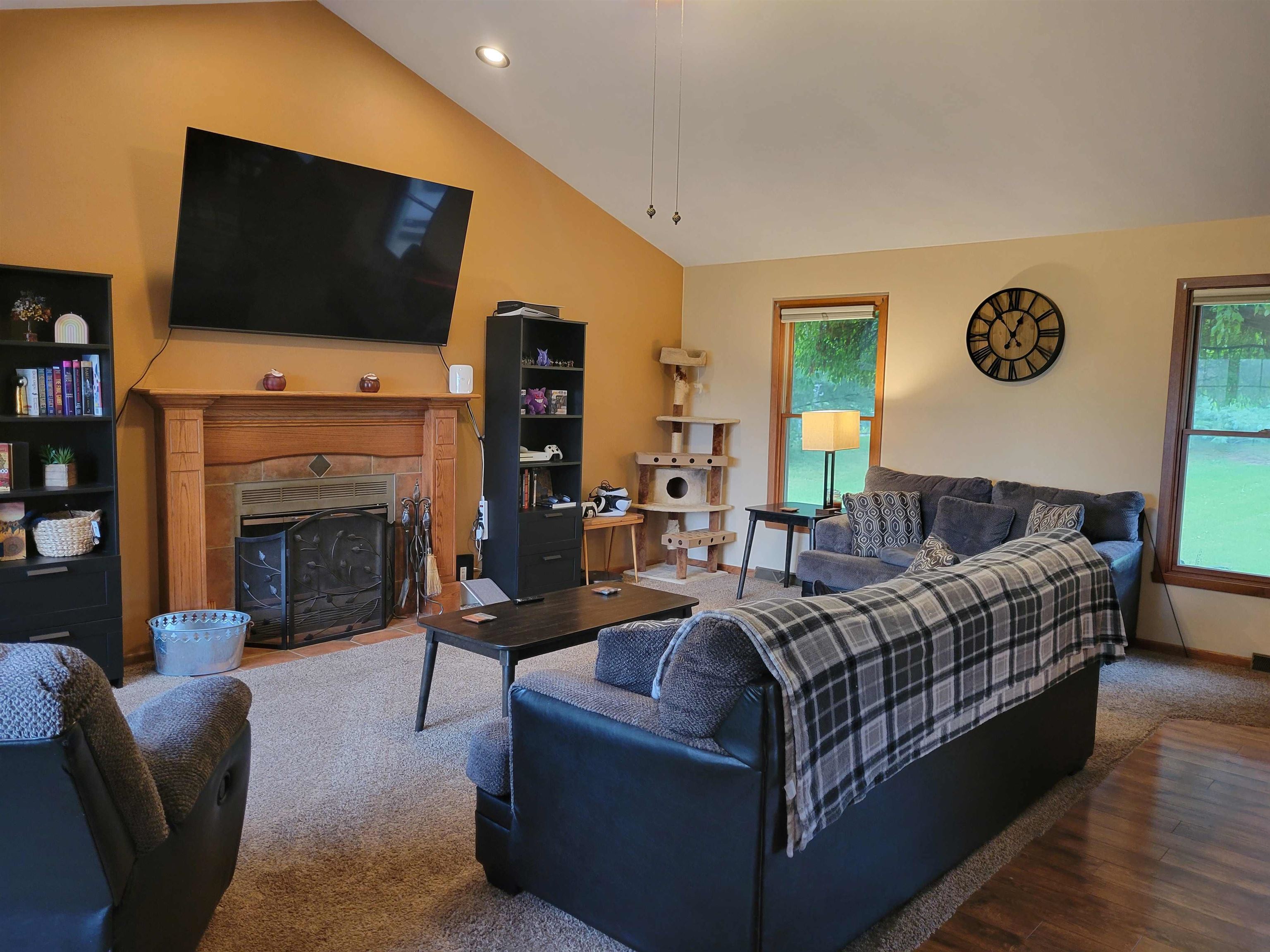 1126 Old Hunter Run Byron, IL 61010 - Photo 5 of 24 a living room with furniture a flat screen tv and a fireplace