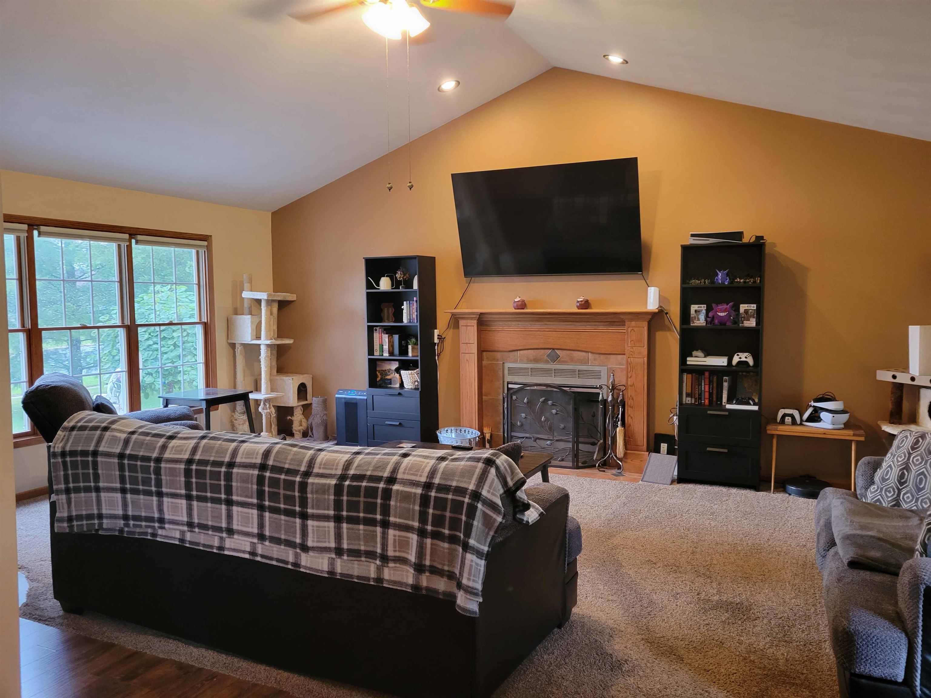 1126 Old Hunter Run Byron, IL 61010 - Photo 7 of 24 a living room with fireplace furniture and a flat screen tv