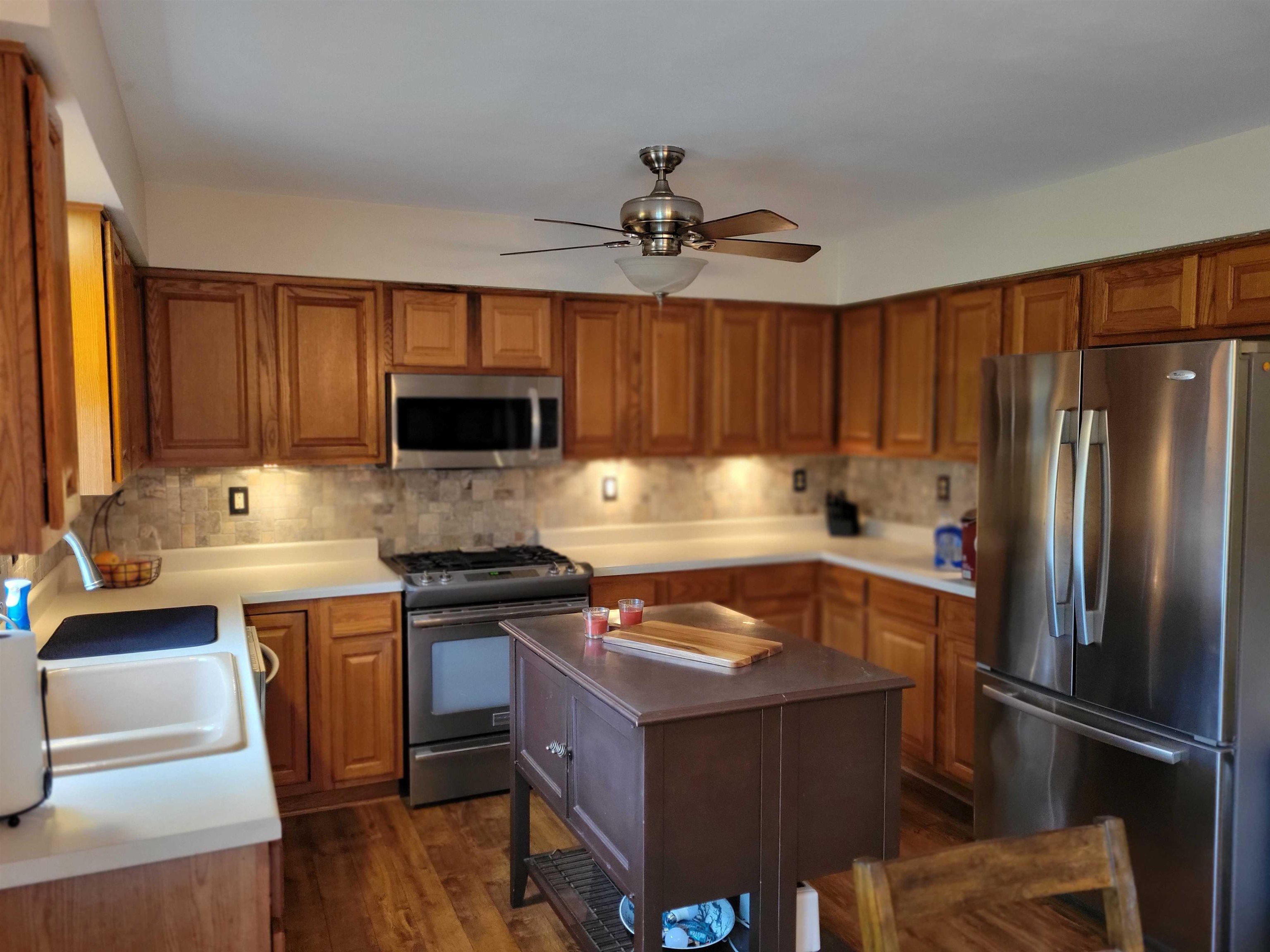 1126 Old Hunter Run Byron, IL 61010 - Photo 9 of 24 a kitchen with wooden cabinets and stainless steel appliances