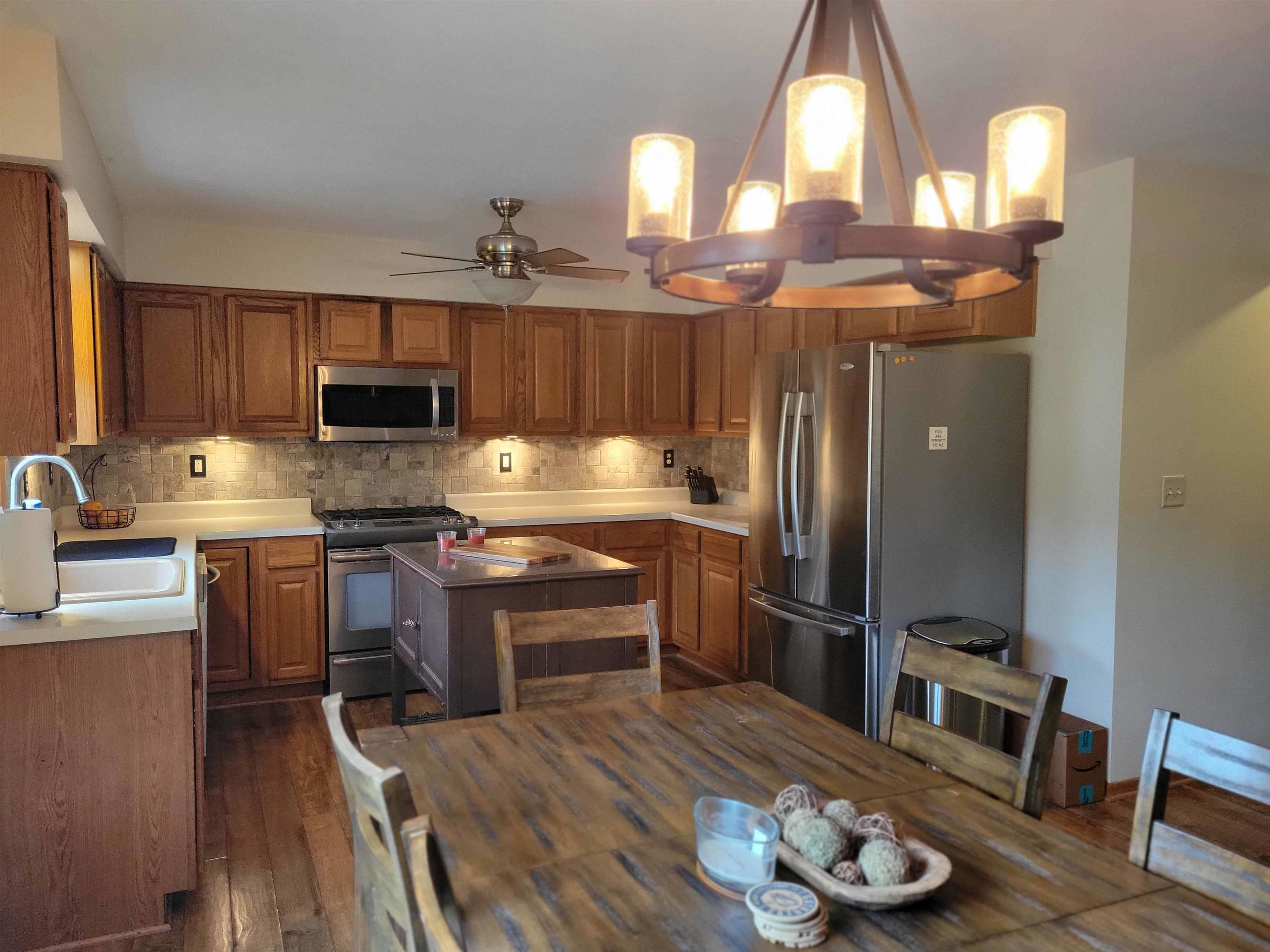 1126 Old Hunter Run Byron, IL 61010 - Photo 10 of 24 a kitchen with granite countertop a refrigerator stove and sink