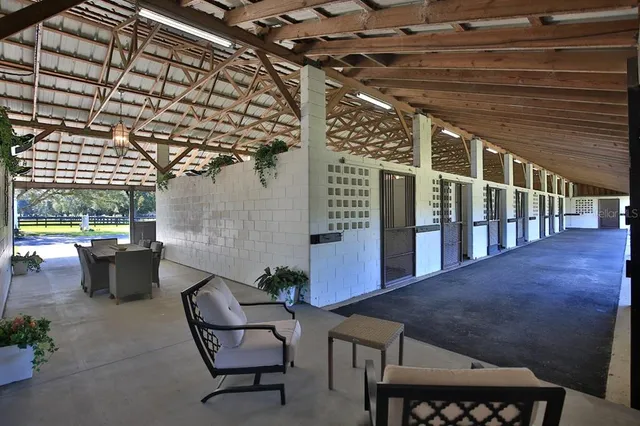 an aerial view of a house with swimming pool and a yard