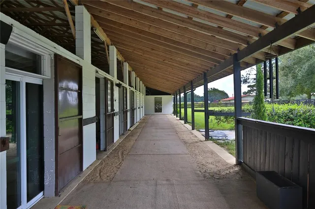 a view of a swimming pool with a yard and plants