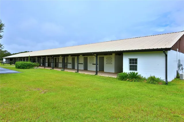 a view of a room with wooden floor and lounge chair