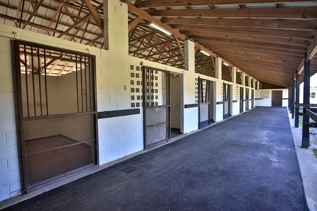 a living room with furniture a flat screen tv and kitchen view