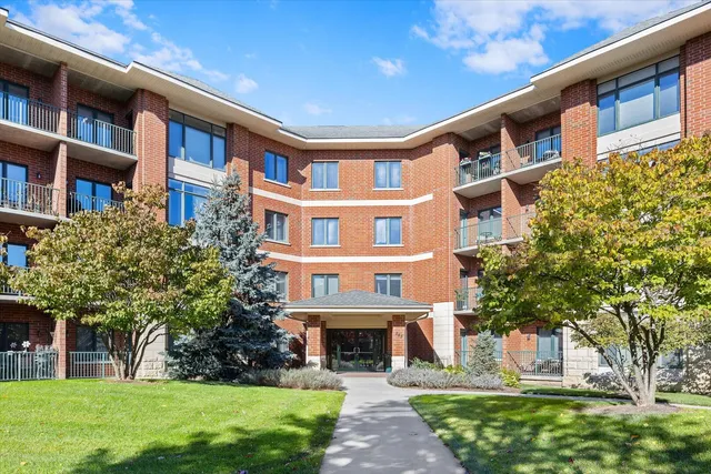 a front view of a building with a garden