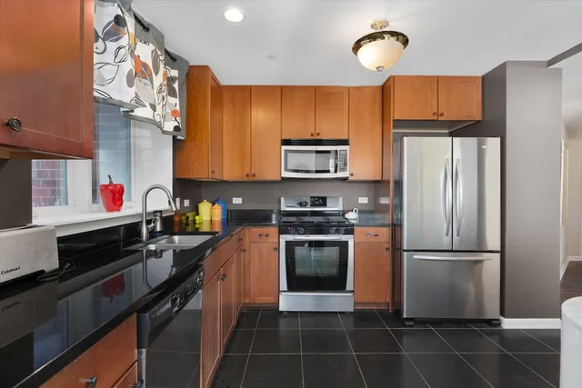 a kitchen with a refrigerator stove and microwave