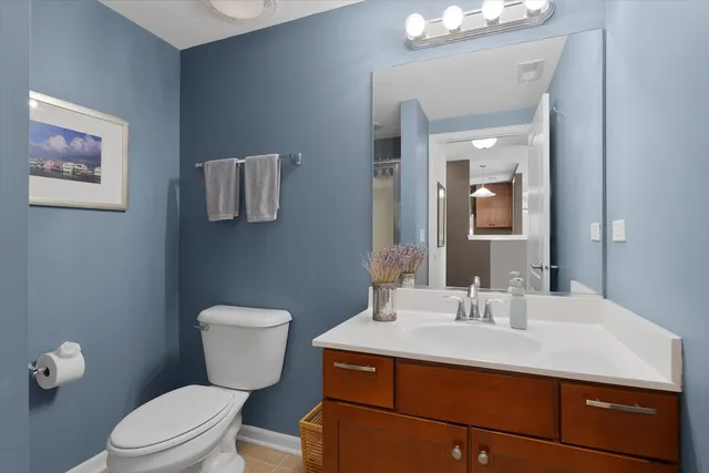 a bathroom with a sink toilet and mirror