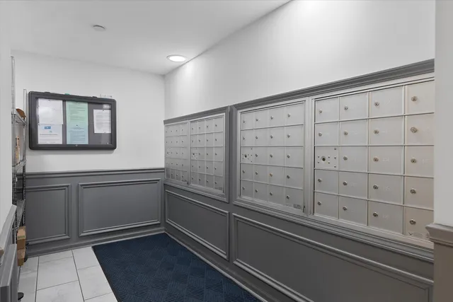a kitchen with white cabinets and sink