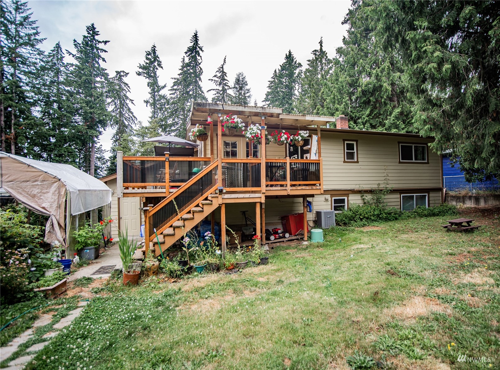 24311 3rd Place West Bothell, WA 98021 - Photo 25 of 30 a view of a house with backyard sitting area and trees