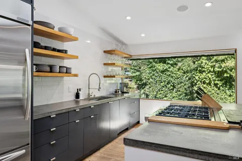 a kitchen with stainless steel appliances a sink a stove and a refrigerator