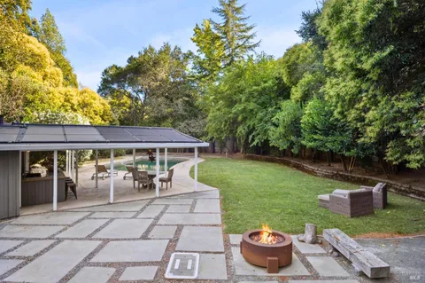 a view of a patio with table and chairs potted plants with wooden fence