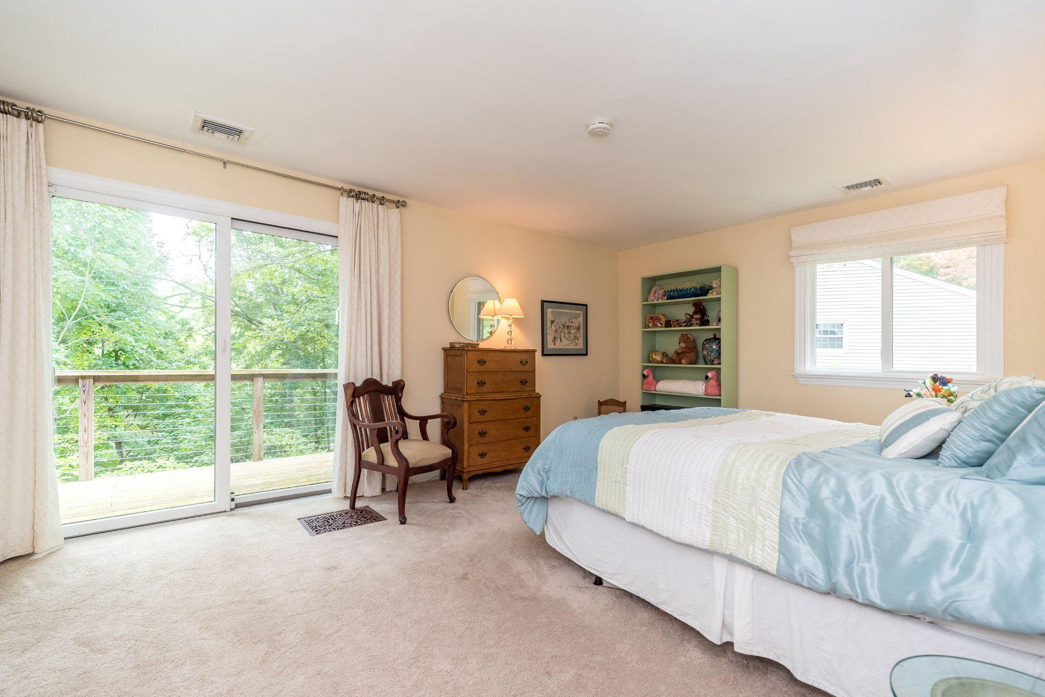 24 Springtree Lane Yardley, PA 19067 - Photo 41 of 84 Serene bedroom with doors leading to deck.