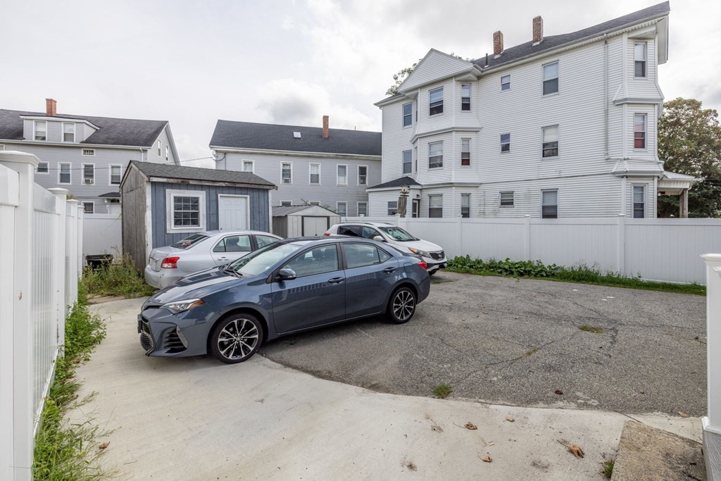 324 Stafford Road Fall River, MA 02721 - Photo 11 of 41 a car parked in front of a white building