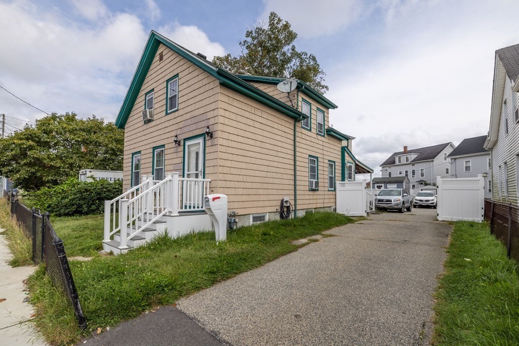 324 Stafford Road Fall River, MA 02721 - Photo 2 of 41 a front view of a house with a yard and garage