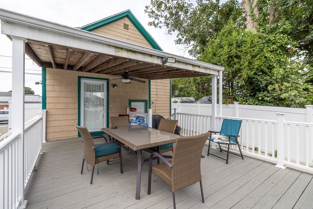 324 Stafford Road Fall River, MA 02721 - Photo 23 of 41 a view of a patio with table and chairs with wooden floor and fence