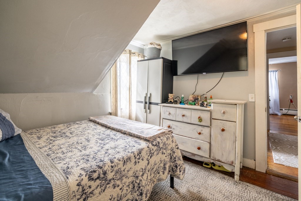 324 Stafford Road Fall River, MA 02721 - Photo 33 of 41 a spacious bedroom with a bed and a flat screen tv