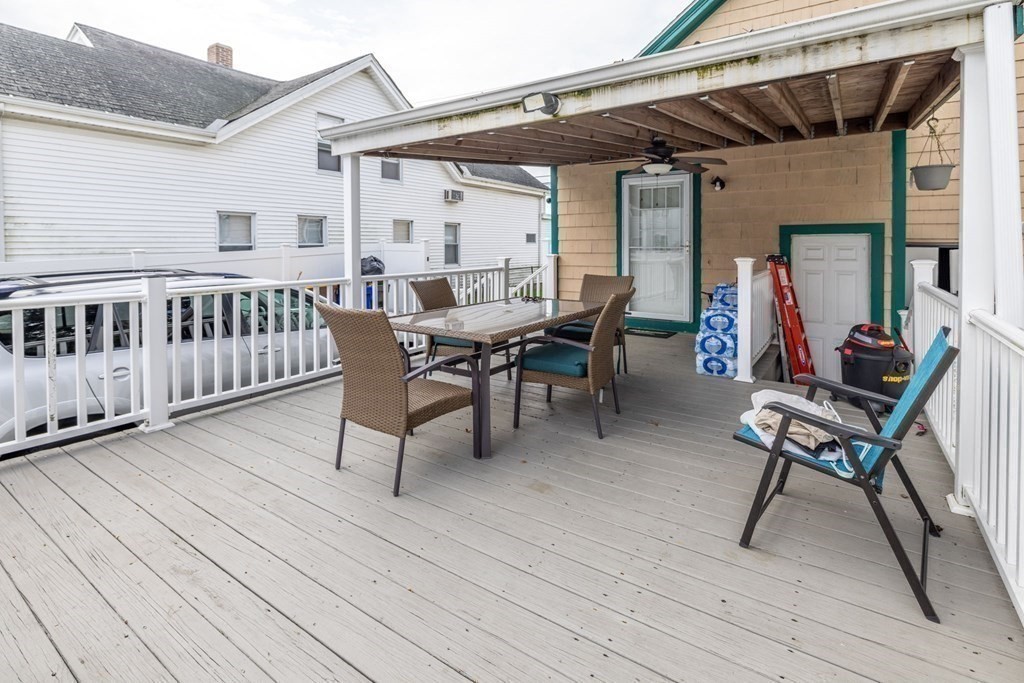 324 Stafford Road Fall River, MA 02721 - Photo 6 of 41 a view of a patio with table and chairs with wooden floor and fence