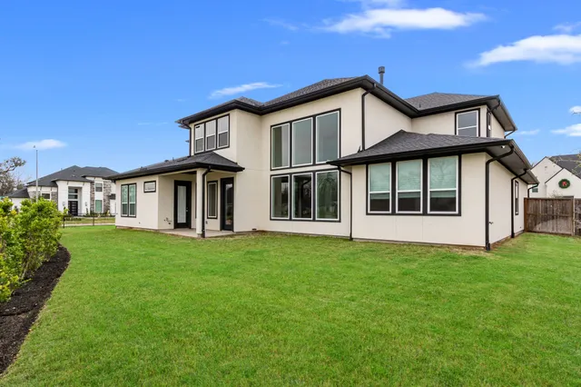 a view of house with yard and sitting area