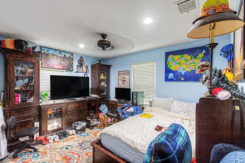 a bedroom with a bed and a flat screen tv