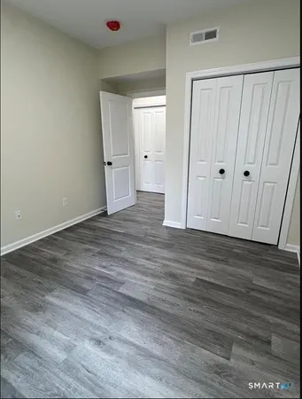 a view of hallway with wooden floor
