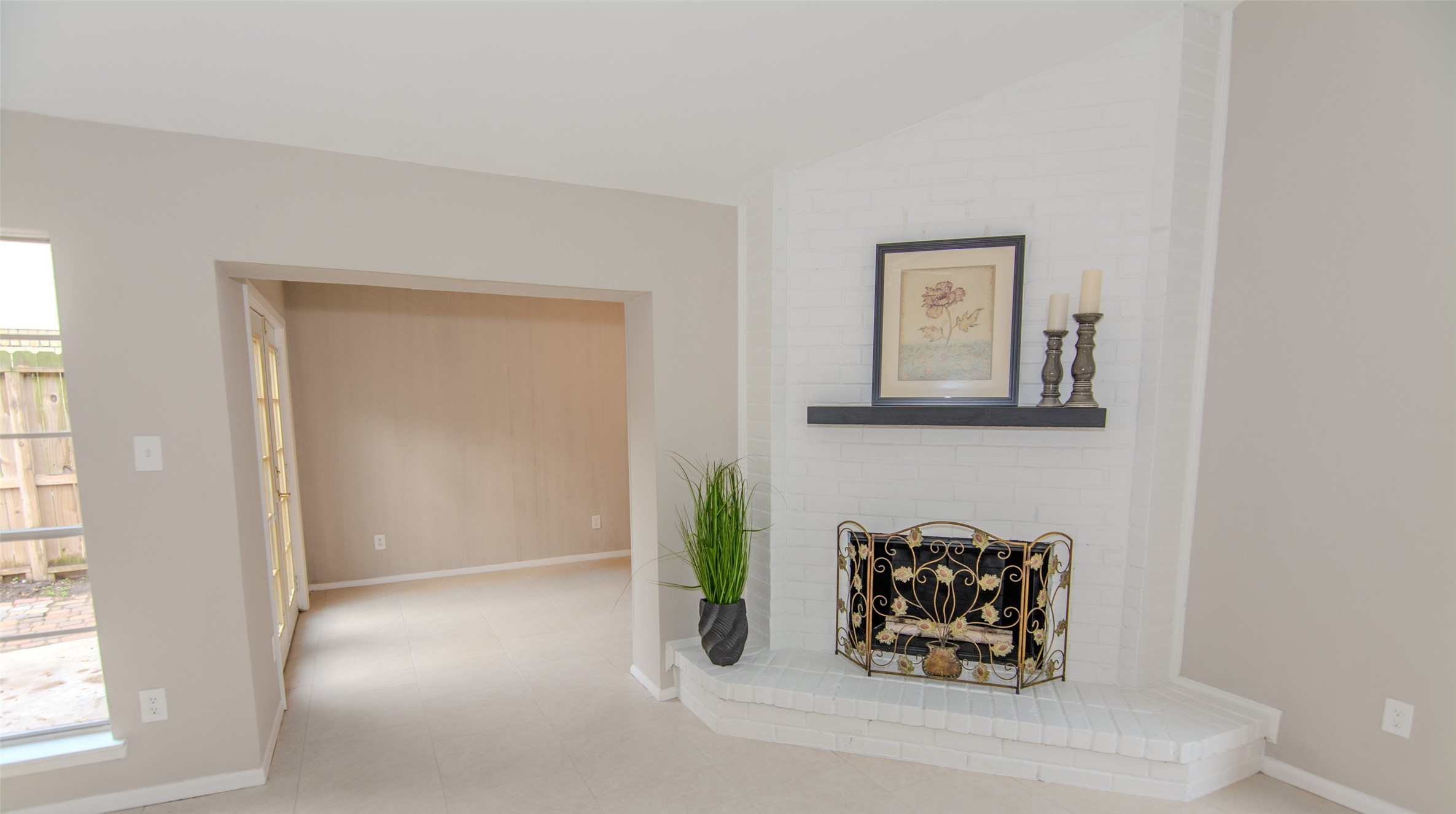 6703 Stonewater Houston, TX 77084 - Photo 14 of 30 Corner white brick fireplace, elegant mantel decor, enjoy those cold winter nights by the fireplace.