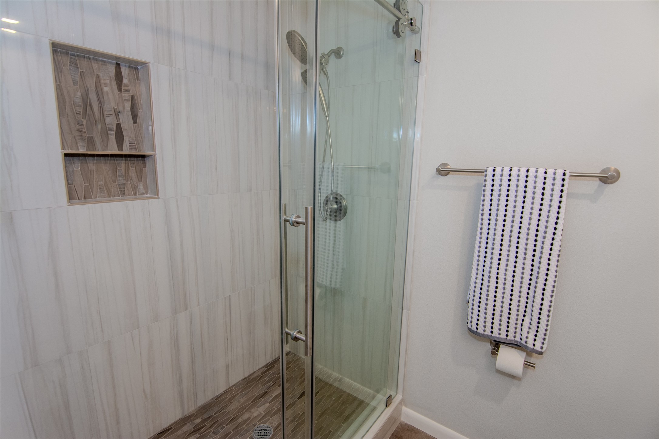 6703 Stonewater Houston, TX 77084 - Photo 23 of 33 Spacious walk-in shower with a barn sliding door, shampoo niche, and pull-down shower head.