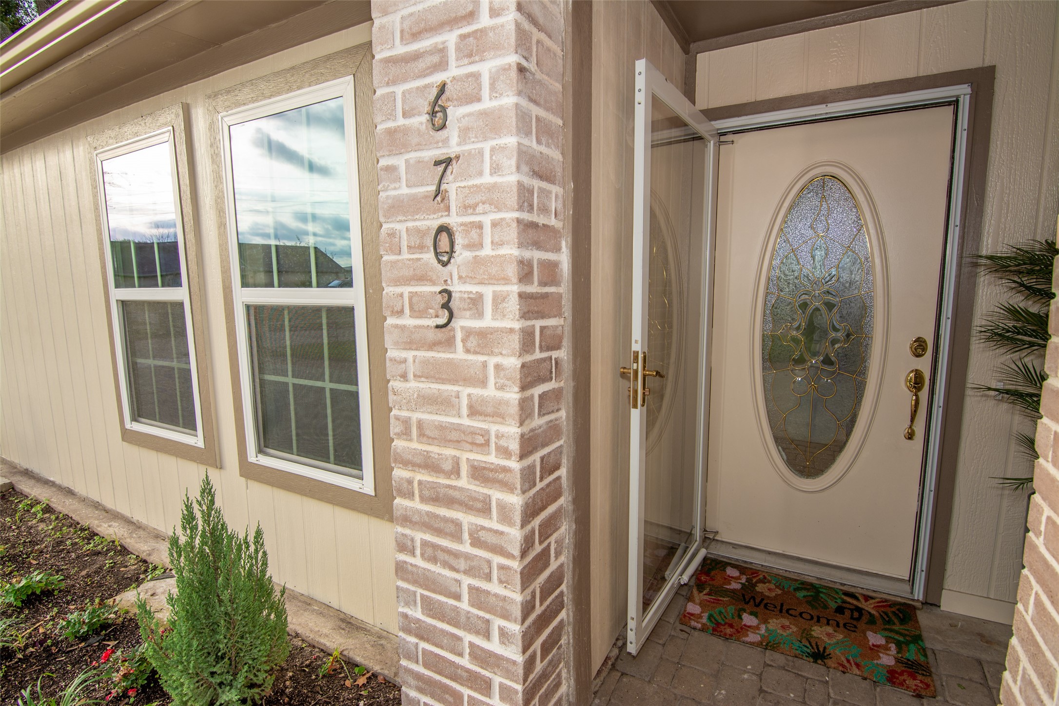 6703 Stonewater Houston, TX 77084 - Photo 30 of 30 Charming entryway with a brick accent wall and an inviting glass-paneled front door.
COME CALL 3706 Stonewater HOME!