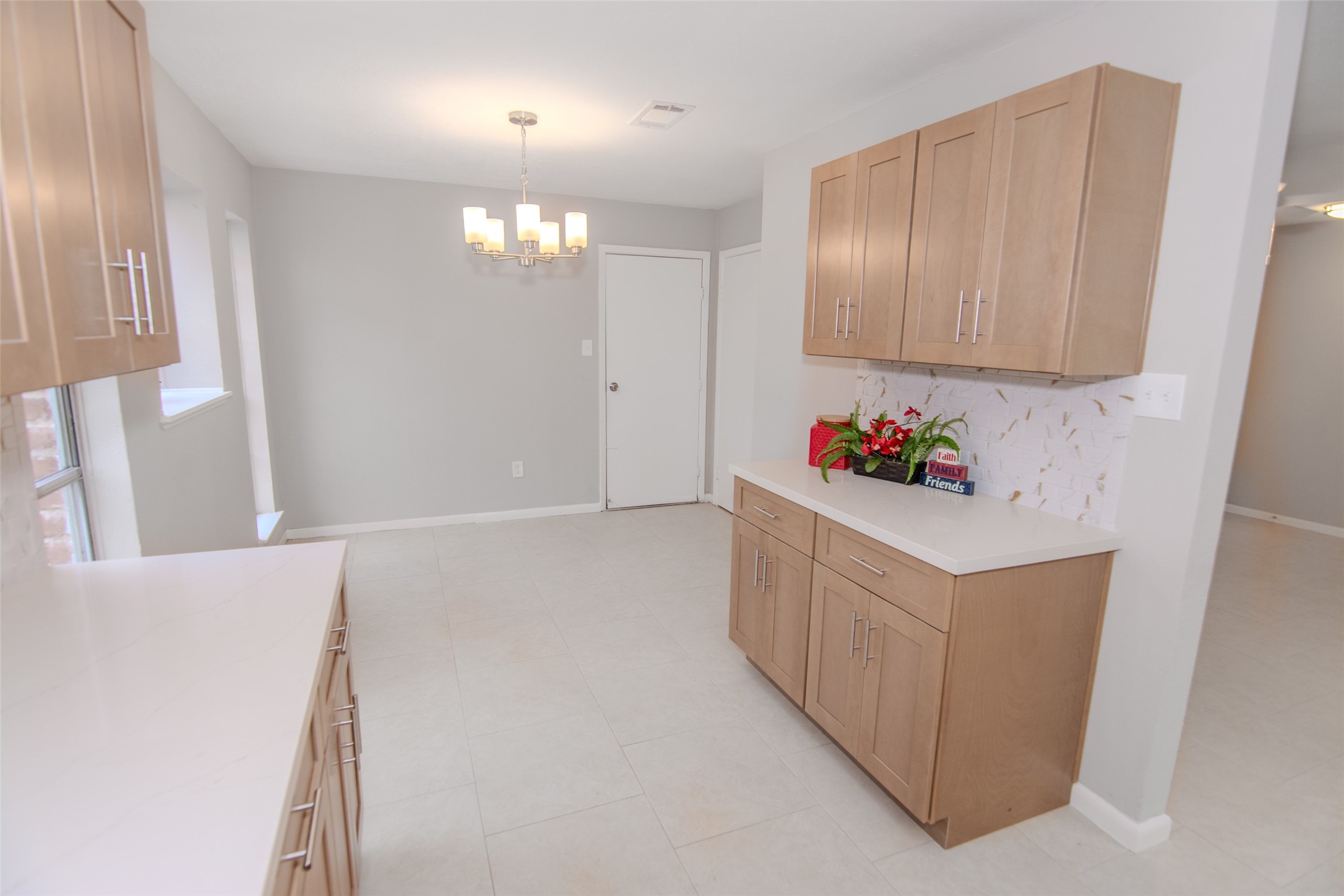 6703 Stonewater Houston, TX 77084 - Photo 4 of 30 Breakfast room has large windows allowing natural light, a contemporary light fixture, and ample space for dining.
