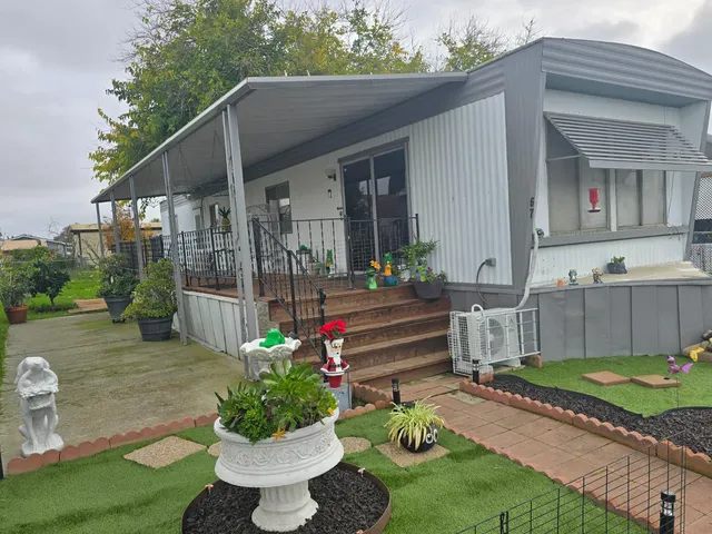 a view of a house with backyard and sitting area