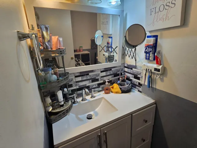 a view of a sink and storage area
