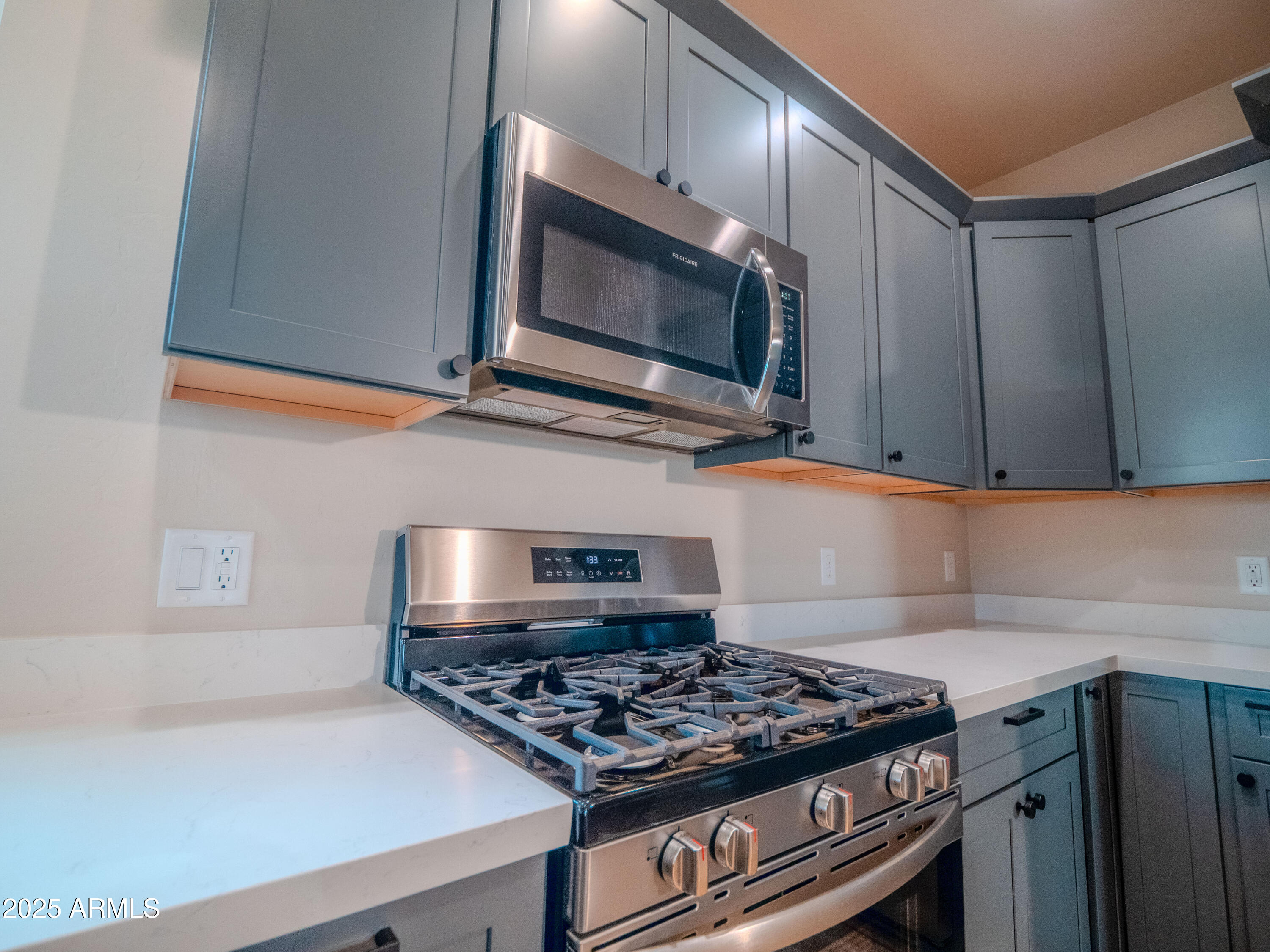 941 South Ridgeway Place Show Low, AZ 85901 - Photo 11 of 67 a kitchen with stainless steel appliances granite countertop a stove and a microwave