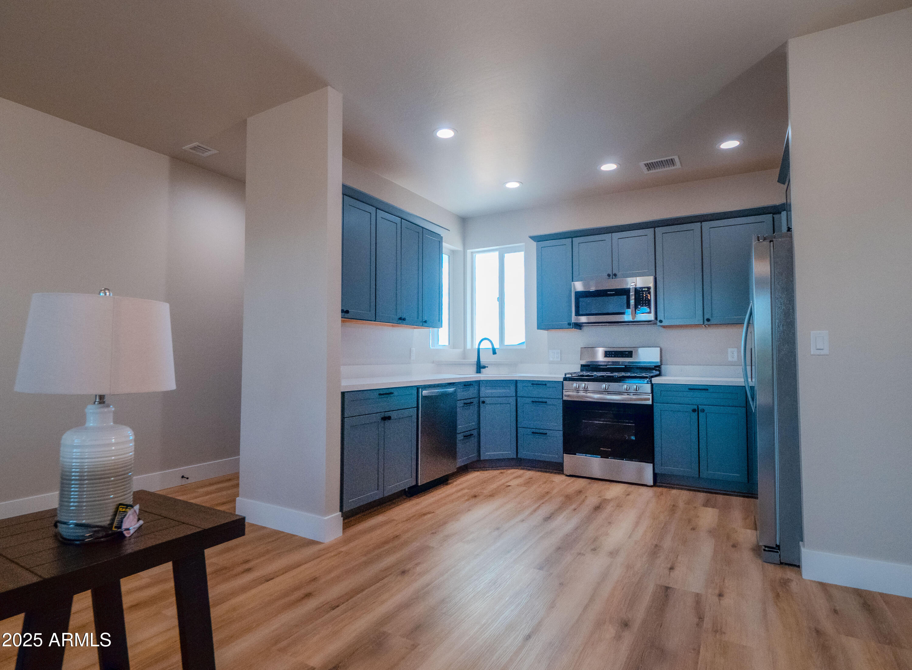 941 South Ridgeway Place Show Low, AZ 85901 - Photo 17 of 67 a kitchen with stainless steel appliances granite countertop a refrigerator a stove top oven and a wooden floors