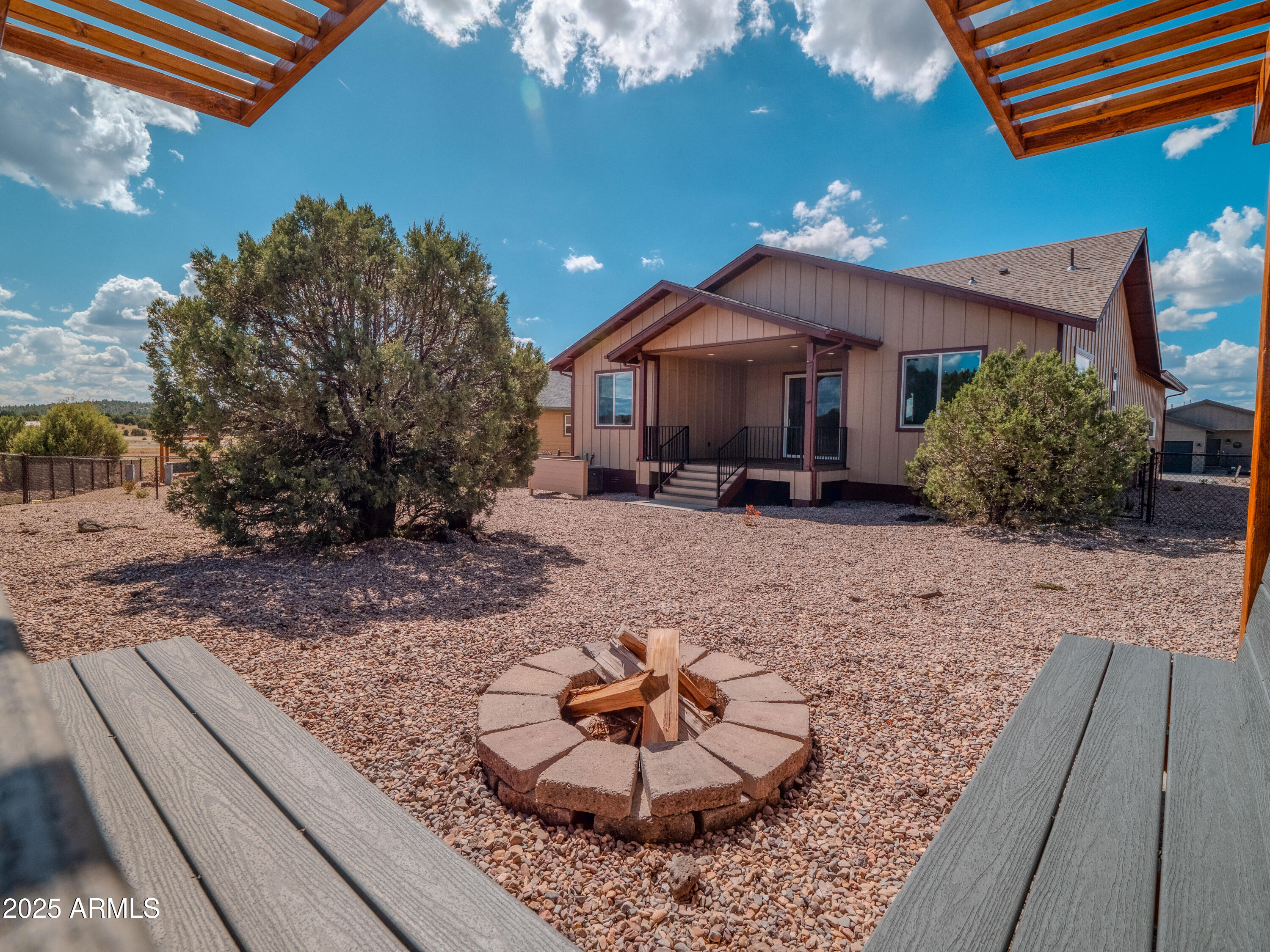 941 South Ridgeway Place Show Low, AZ 85901 - Photo 41 of 67 a backyard of a house with a garden and barbeque oven